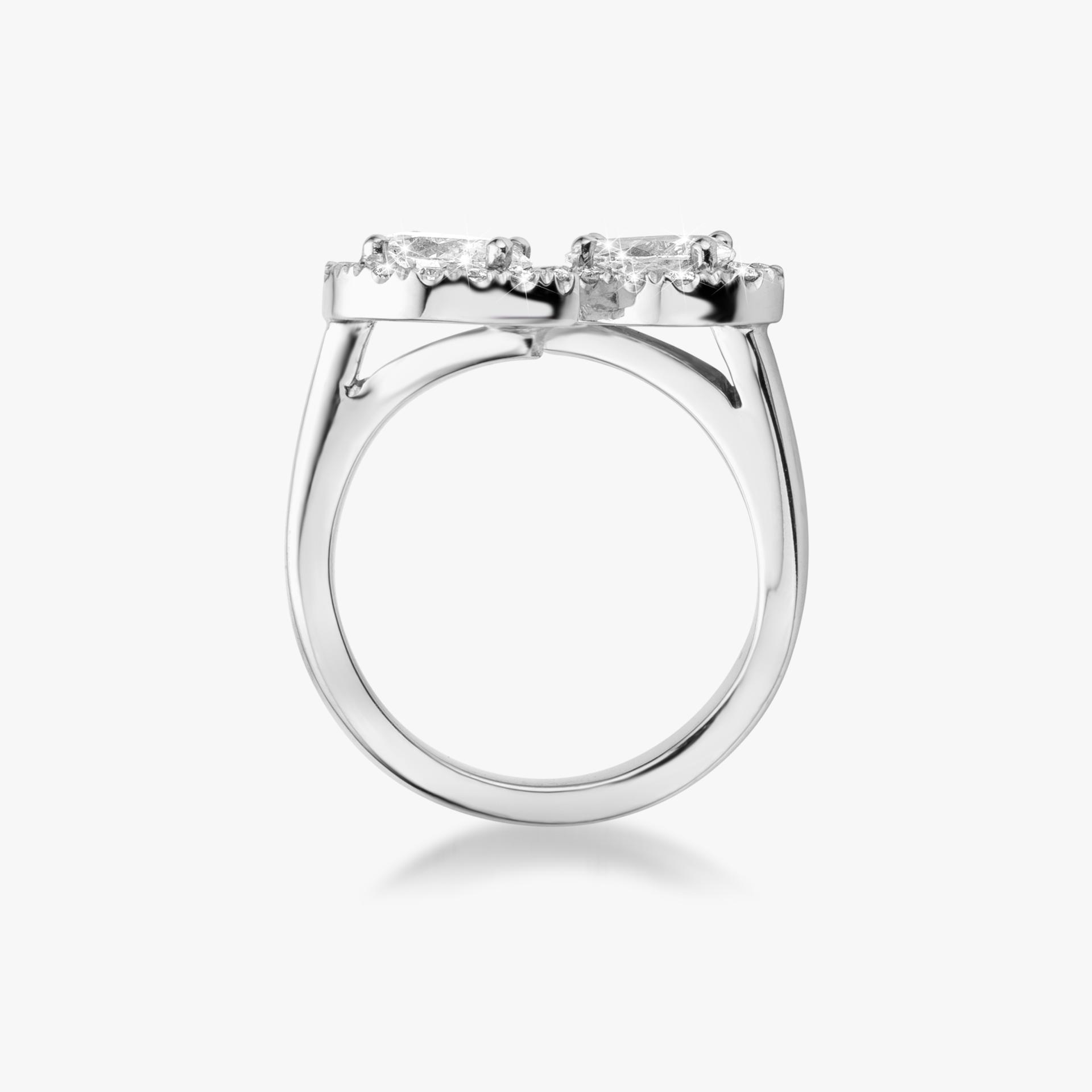 White gold ring set with pear cut and brilliant cut diamonds made by Maison De Greef