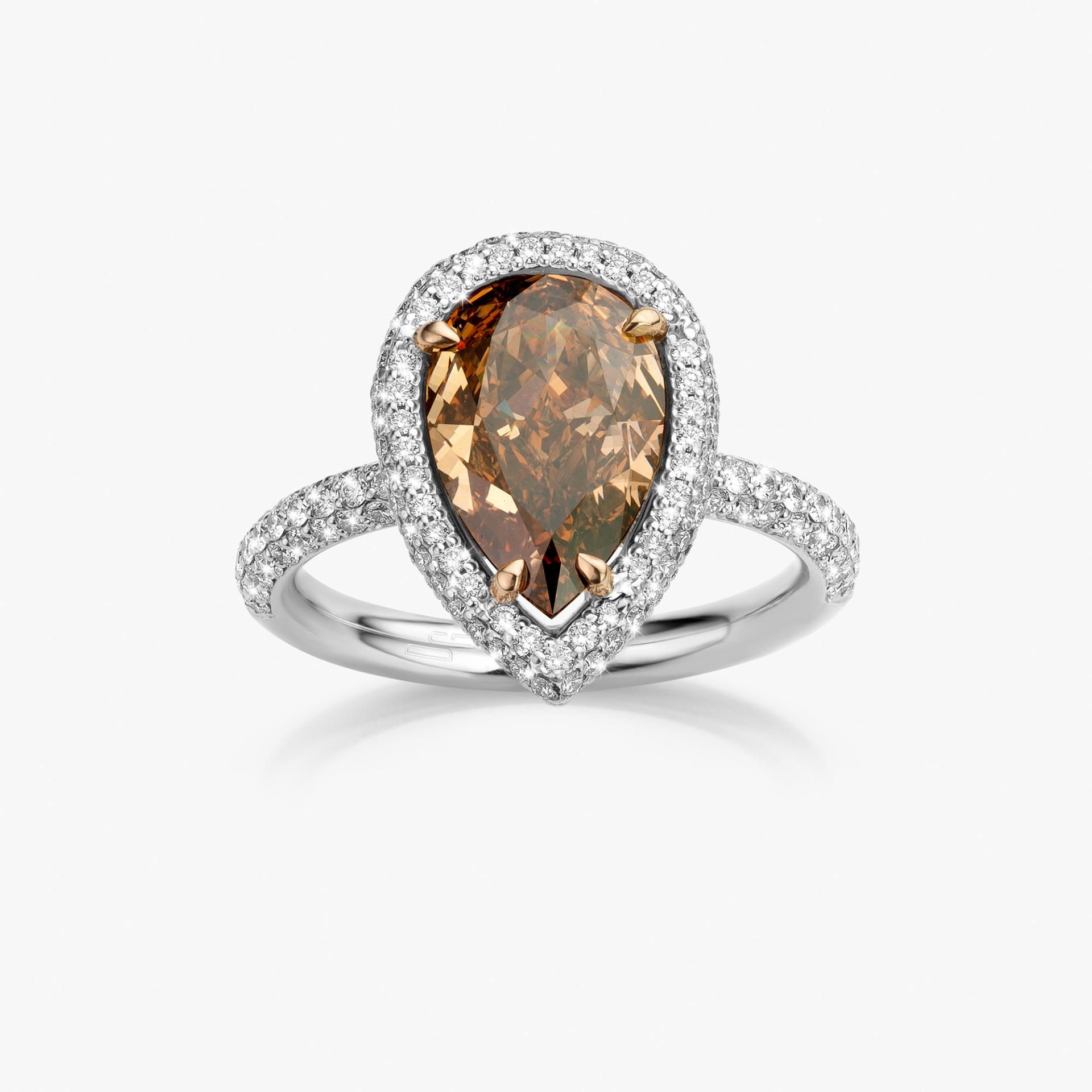 White gold ring set with pear shaped brown diamond and diamonds made by Maison De Greef