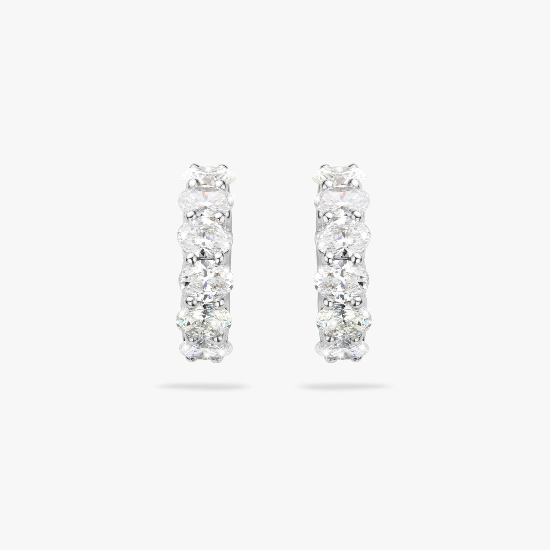 White gold earrings set with oval shaped diamonds made by Maison De Greef