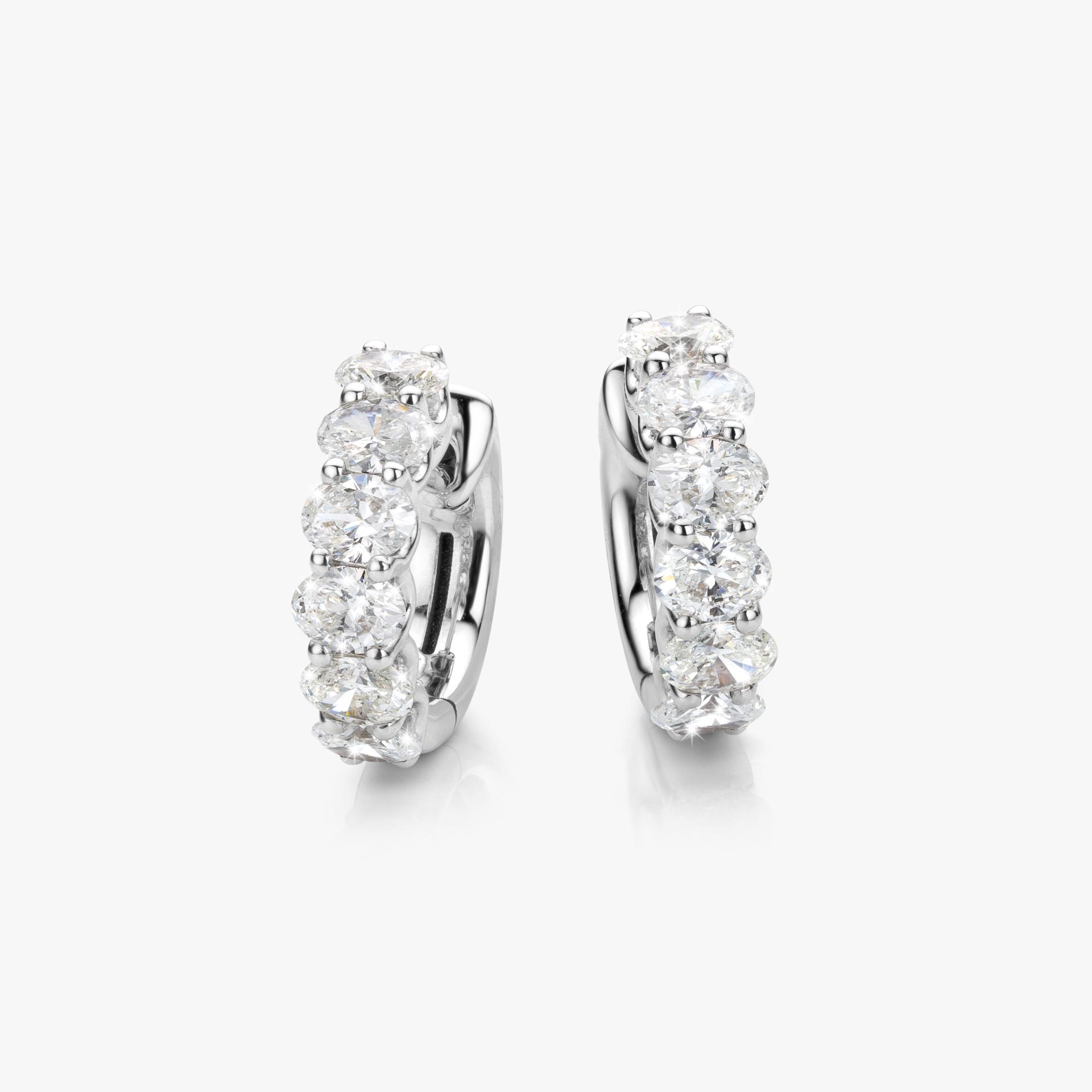 White gold earrings set with oval shaped diamonds made by Maison De Greef