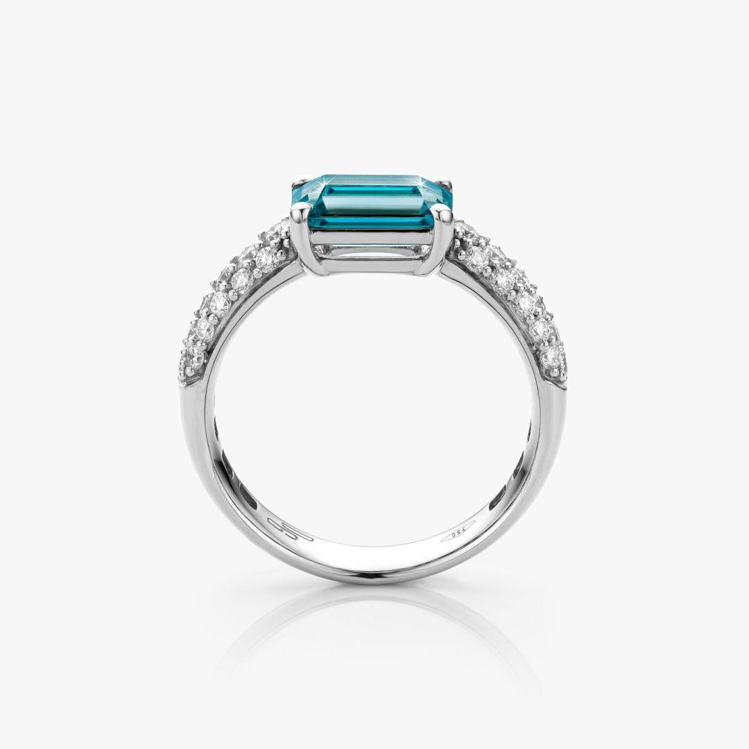 White gold ring set with blue zircon and diamonds made by Maison De Greef