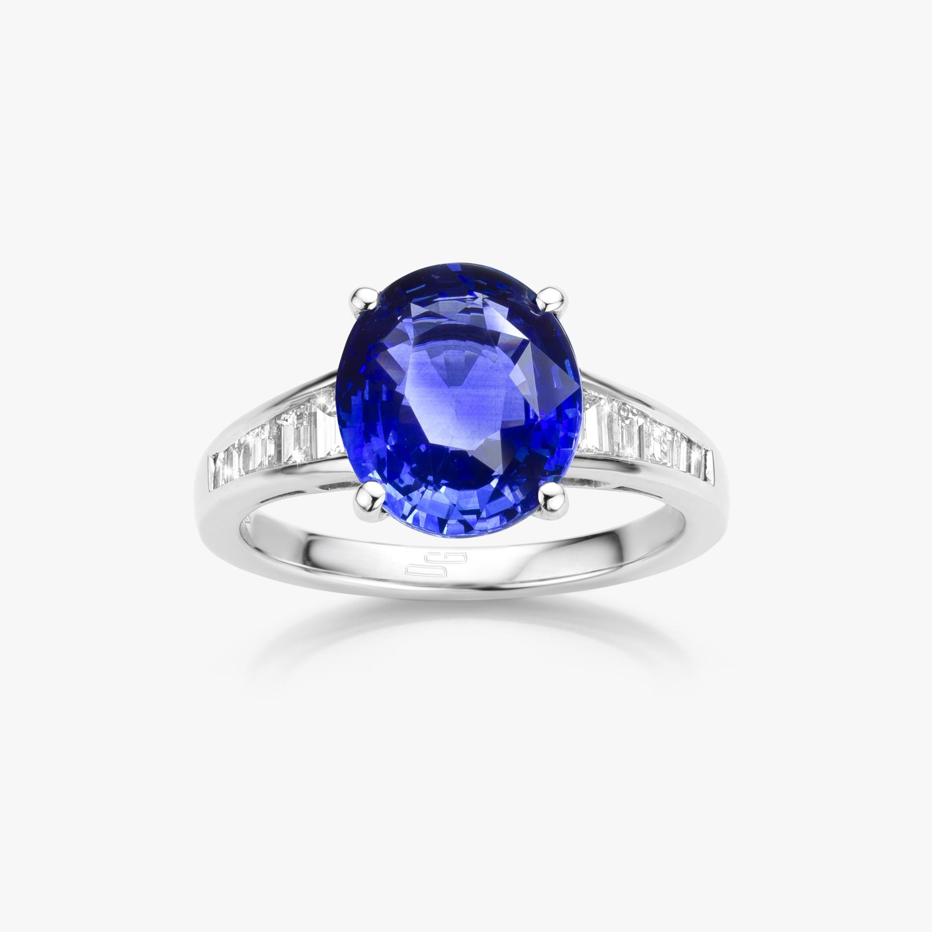 White gold ring set with oval shaped blue sapphire and emerald shaped diamonds made by Maison De Greef