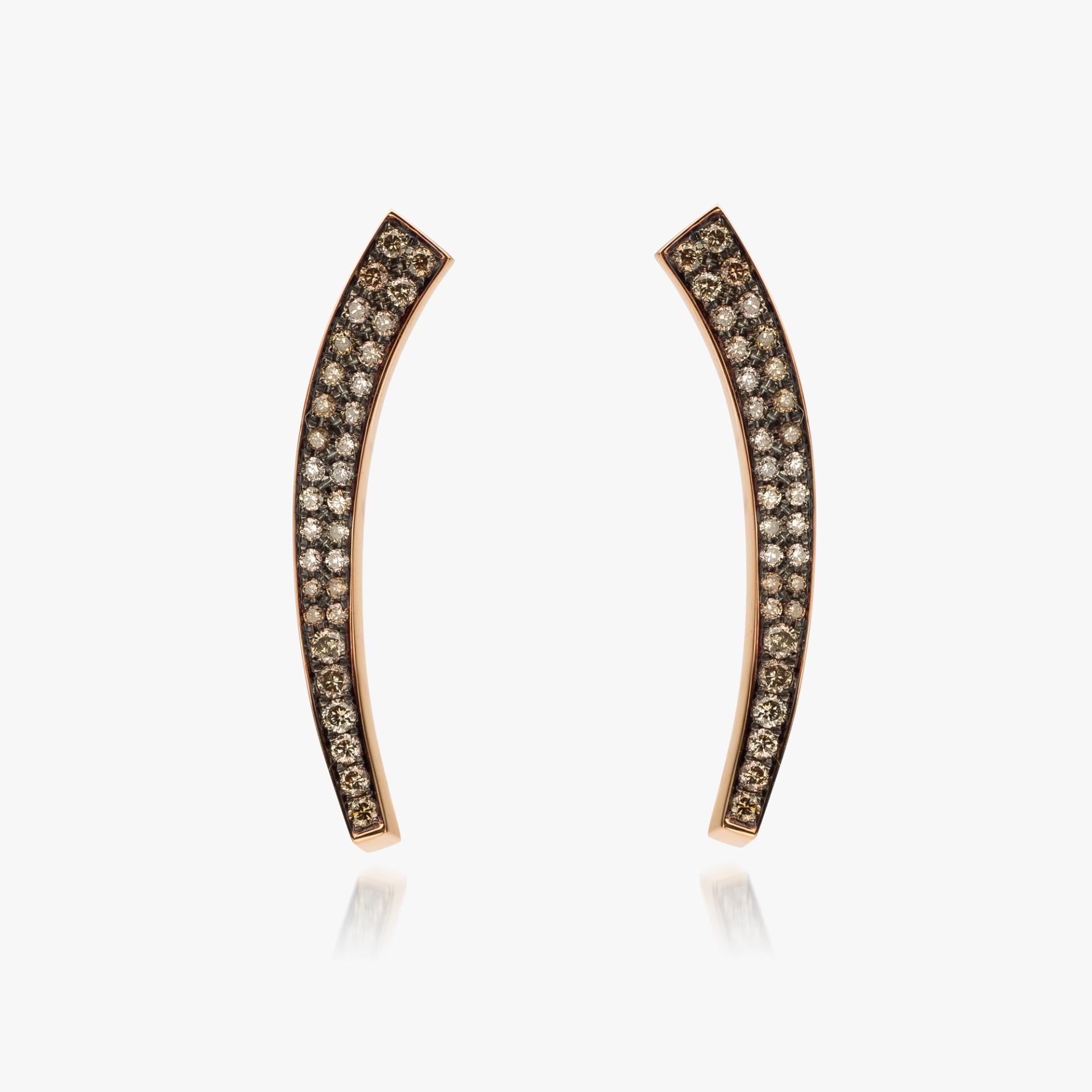 Assymetrical rose gold earrings set with diamonds made by Maison De Greef